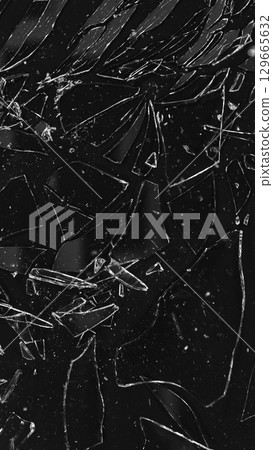 Dirty Glass Broken into a Large Number of Pieces and Parts, a Piece of Glass with a lot of Cracks and Broken Parts. Isolated on Black Background. 129665632