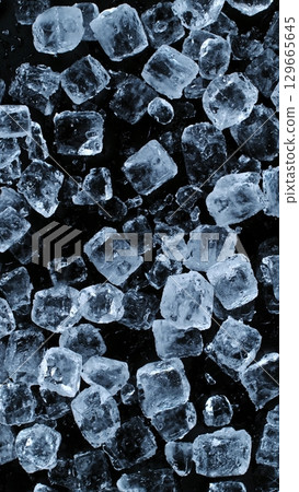 Ice Cubes. Textured Ice on a Black Background, Close-up. Abstract Background, Flying Ice. Vertical Aspect Ratio. 129665645