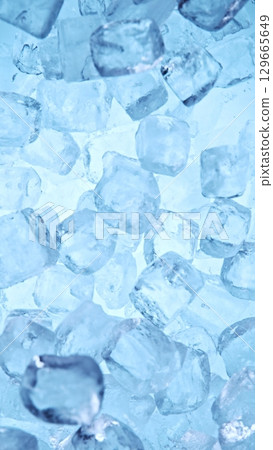 Ice Cubes. Textured Ice on a Blue Background, Close-up. Abstract Background, Flying Ice. Vertical Aspect Ratio. 129665649