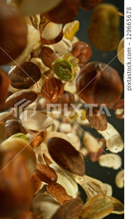 Freeze Motion of Flying Mix of Nuts. Abstract Food Background. 129665678