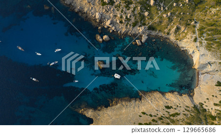 Aerial view of beautiful bay with turquoise water and longtail boats anchoring. Travel photo, Mallorca, Spain. 129665686