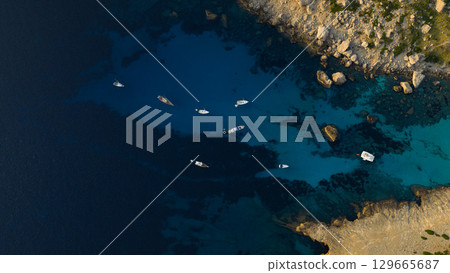 Aerial view of beautiful bay with turquoise water and longtail boats anchoring. Travel photo, Mallorca, Spain. 129665687