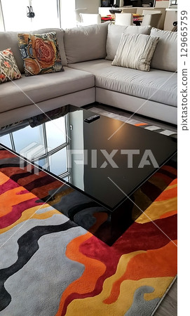 Living room with a black coffee table and a white couch 129665759