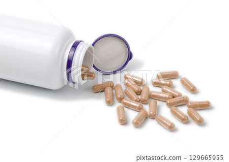 Capsule-type medicine coming out of a container Capsule-type medicine coming out of a container 129665955