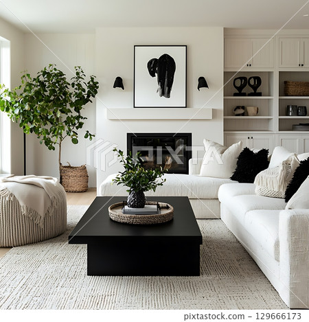 A living room with a black coffee table and white couch A living room with a black coffee table and white couch 129666173