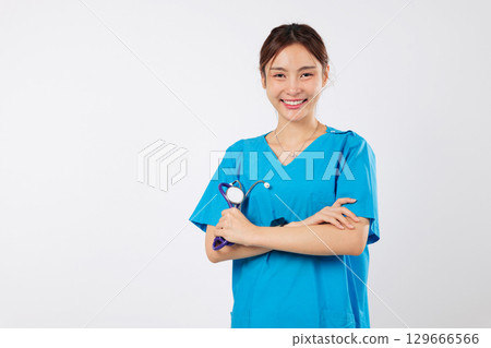 Confident asian doctor, woman in service, medic, healthcare, standing with crossed arms, is smiling nurse in medical uniform ready to offer best help, friendly nurse, isolated white background 129666566