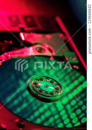 moving hard drive head with green data on drive 129666682