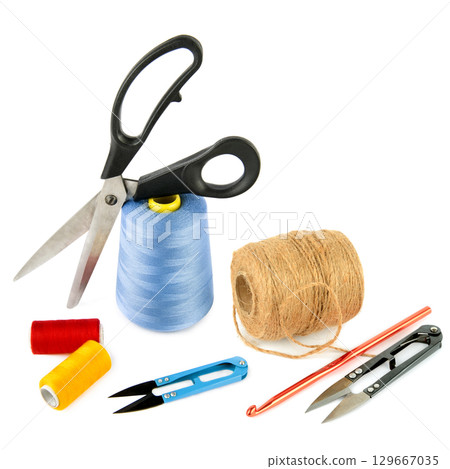 Ball of hemp rope, crochet hook and scissors isolated on white background. Ball of hemp rope, crochet hook and scissors isolated on white background. 129667035
