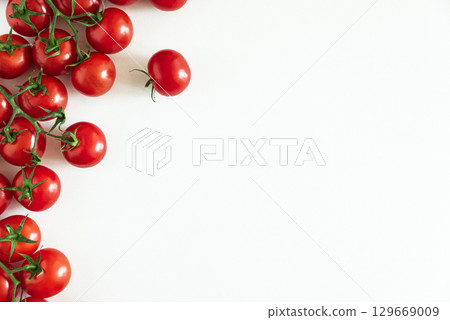 Fresh red cherry tomatoes on a white background. Top view. Copy space Fresh red cherry tomatoes on a white background. Top view. Copy space 129669009