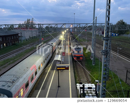 A railway station with two trains on the tracks. A railway station with two trains on the tracks. 129669054