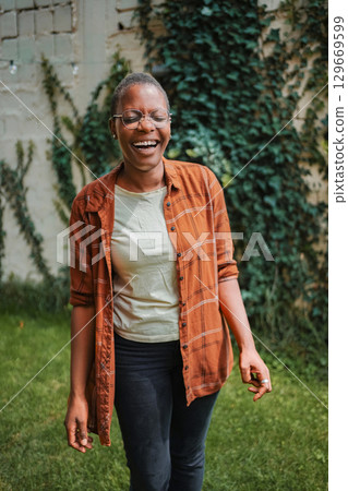 Young African American Woman Laughing in a Garden 129669599