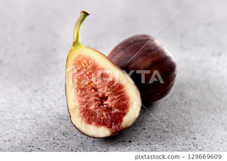 Fresh figs fruit on a gray background. Close up Fresh figs fruit on a gray background. Close up 129669609