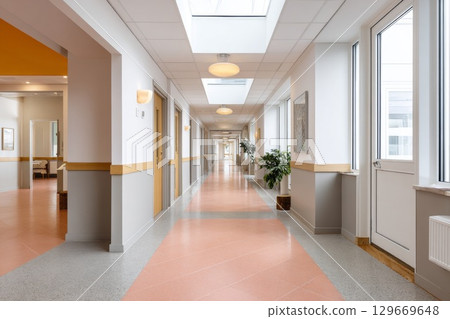 Rubber flooring in a modern corridor with natural light and vibrant colors enhancing the space 129669648