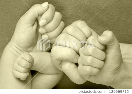 Family bonds are strong as hands connect in a tender moment of togetherness 129669715