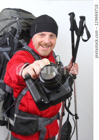 Hiking enthusiast ready for the adventure with camera in hand 129669718