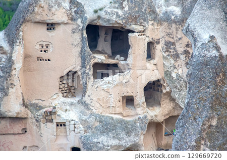 Ancient rock-cut dwellings in Cappadocia, Turkey showcasing unique geological formations Ancient rock-cut dwellings in Cappadocia, Turkey showcasing unique geological formations 129669720