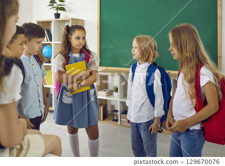 Group of shy children meet for the first time in the classroom on the first day of school Group of shy children meet for the first time in the classroom on the first day of school 129670076