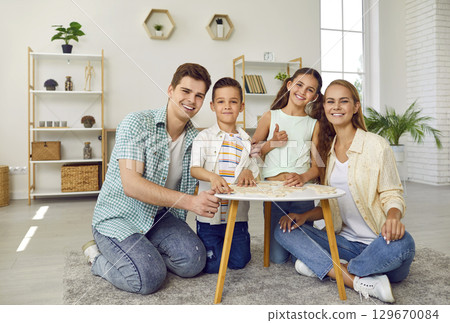 Portrait photo of young beautiful parents and their happy children. 129670084