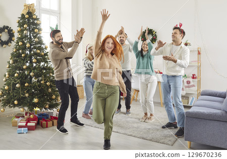 Happy people friends having party, dancing at home celebrating New Year or Christmas together. Happy people friends having party, dancing at home celebrating New Year or Christmas together. 129670236
