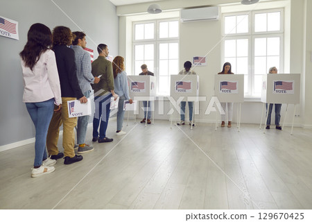 People standing in a queue with ballot paper at polling station at vote center. People standing in a queue with ballot paper at polling station at vote center. 129670425