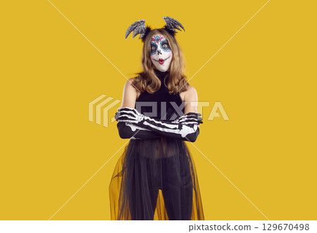 Portrait of child in Halloween costume looking at camera with funny surprised expression Portrait of child in Halloween costume looking at camera with funny surprised expression 129670498