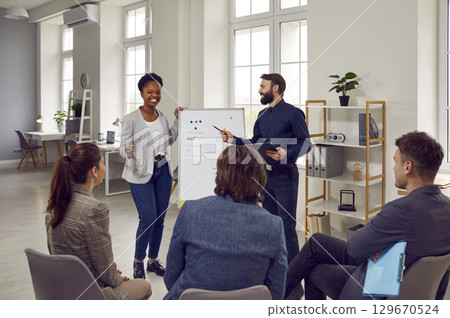 Team of happy people having fun during a business presentation at a work meeting 129670524