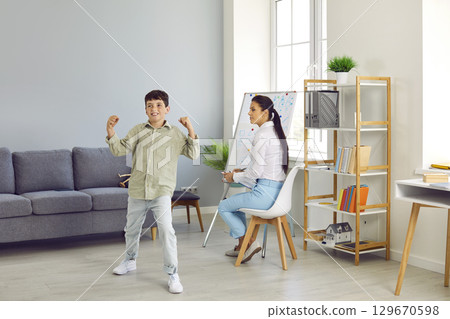 Hyperactive ADHD child or bully boy at therapist's or school psychologist's office 129670598