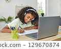 Remote Education. Happy schoolgirl doing homework together. 129670874