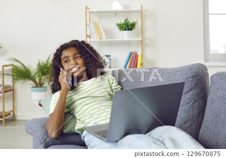 Nice African American teenage girl talking on phone Nice African American teenage girl talking on phone 129670875