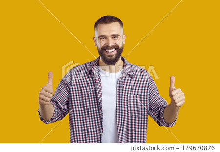 Joyful man approving, making positive hand gesture, smiling and enjoying success. Joyful man approving, making positive hand gesture, smiling and enjoying success. 129670876