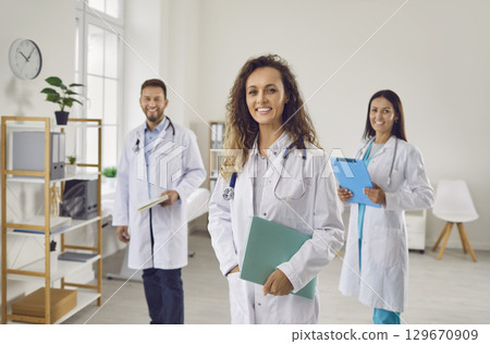 Smiling Hospital Team of Doctors and Nurses in Group Portrait Smiling Hospital Team of Doctors and Nurses in Group Portrait 129670909