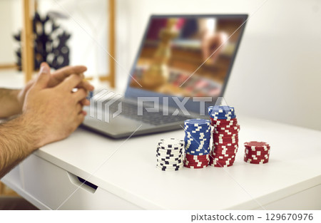 Cropped shot of male gambler playing online roulette game Cropped shot of male gambler playing online roulette game 129670976
