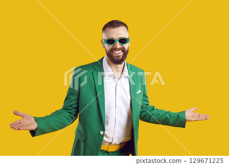 Funny man in green suit and sunglasses spreads arms and welcomes you to St Patrick's Day party Funny man in green suit and sunglasses spreads arms and welcomes you to St Patrick's Day party 129671225