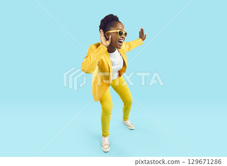 Funny nosy african american woman eavesdropping isolated on light blue background. Funny nosy african american woman eavesdropping isolated on light blue background. 129671286