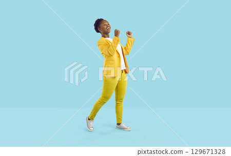 Happy laughing african american woman showing yes gesture isolated on turquoise background. 129671328