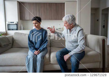 Old couple divorce. Elderly man with hysterical behavior toward upset wife with accusations insults 129671329