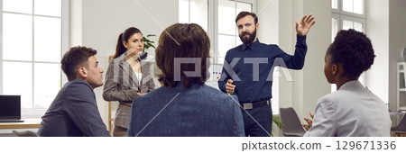 Multiethnic people man and woman watch manager presentation in office with large windows 129671336