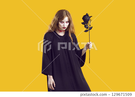 Portrait of mysterious Halloween woman who looks at you with evil, creepy and gloomy look. Portrait of mysterious Halloween woman who looks at you with evil, creepy and gloomy look. 129671509