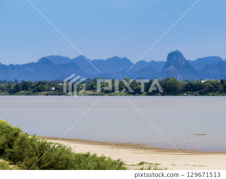 View of the Mekong River and the mountains of Laos from Nakhon Phanom in northeastern Thailand View of the Mekong River and the mountains of Laos from Nakhon Phanom in northeastern Thailand 129671513