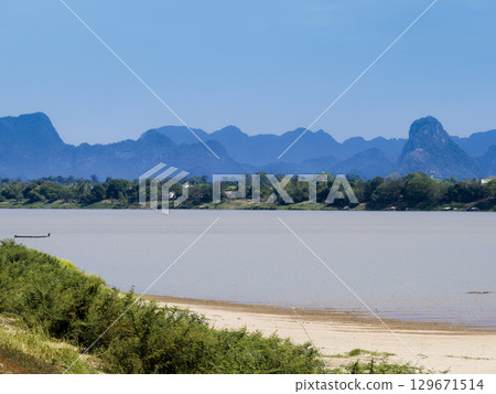 View of the Mekong River and the mountains of Laos from Nakhon Phanom in northeastern Thailand View of the Mekong River and the mountains of Laos from Nakhon Phanom in northeastern Thailand 129671514