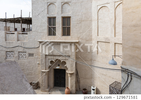 Old town in Al Seef Cultural Historical District on shores of Dubai Creek. Tourist place with old streets, houses and shops, Dubai, UAE 129671581