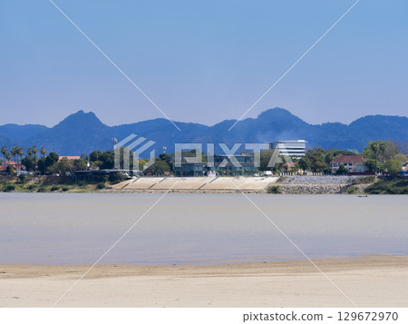 View of the town and mountains of Thakhek in Laos across the Mekong River from Nakhon Phanom in Thailand View of the town and mountains of Thakhek in Laos across the Mekong River from Nakhon Phanom in Thailand 129672970