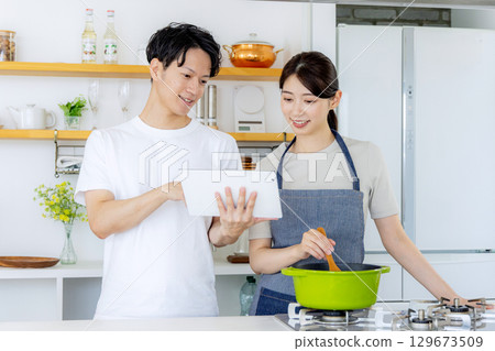 Young couple cooking in the kitchen 129673509