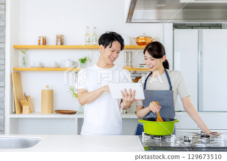 Young couple cooking in the kitchen 129673510
