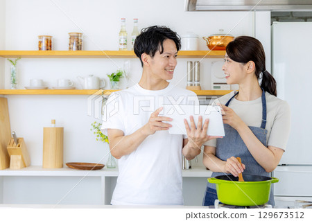 Young couple cooking in the kitchen 129673512