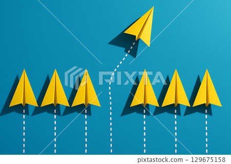 A row of yellow airplanes led by a yellow leader airplanes in a line as leadership in alignment A row of yellow airplanes led by a yellow leader airplanes in a line as leadership in alignment 129675158