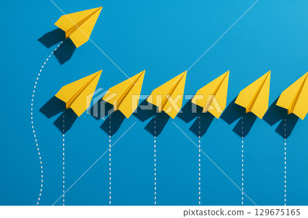 Four yellow airplanes in front leading blue airplanes in a square arrangement representing structured leadership Four yellow airplanes in front leading blue airplanes in a square arrangement representing structured leadership 129675165