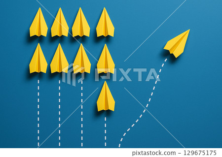 Two yellow airplanes ahead of white ones in a triangle structure for dual leadership strategy 129675175