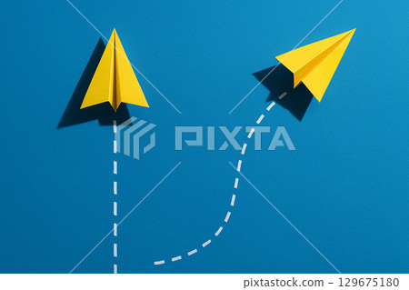 A yellow airplane changing direction from the group with dotted path highlighting bold leadership moves A yellow airplane changing direction from the group with dotted path highlighting bold leadership moves 129675180