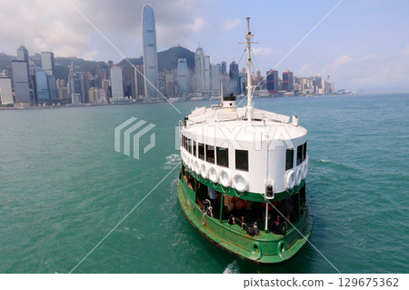 Star ferry sailing through Victoria Bay in Hong Kong 129675362